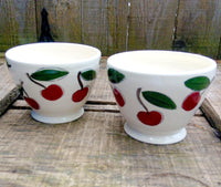 Two coffee cozy bowls handmade and handtrown made of porcelain with cherries pattern